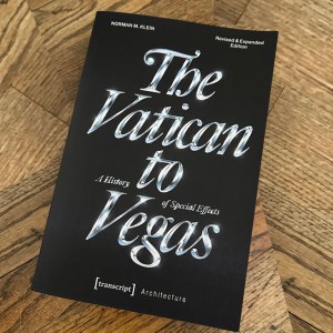 Cover of "The Vatican to Vegas" book on a wood textured floor